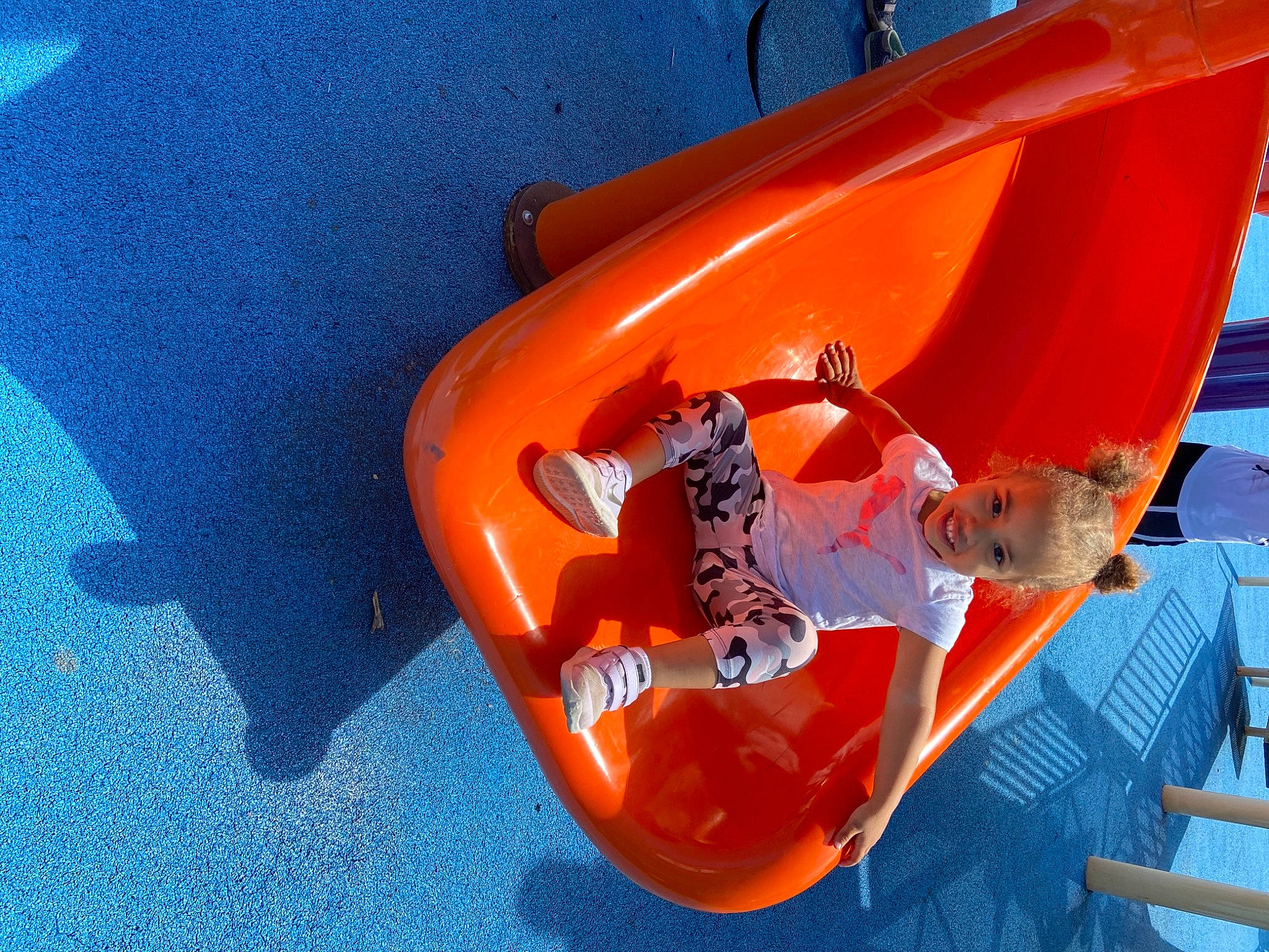 Paityn is registered to the contest to win money with this photo: automotive_exterior, boats_and_boating_equipment_and_supplies, bumper, child, chute, electric_blue, fun, games, hood, inflatable, joy, leisure, orange, outdoor_play_equipment, person, personal_protective_equipment, plastic, play, playground, playground_slide