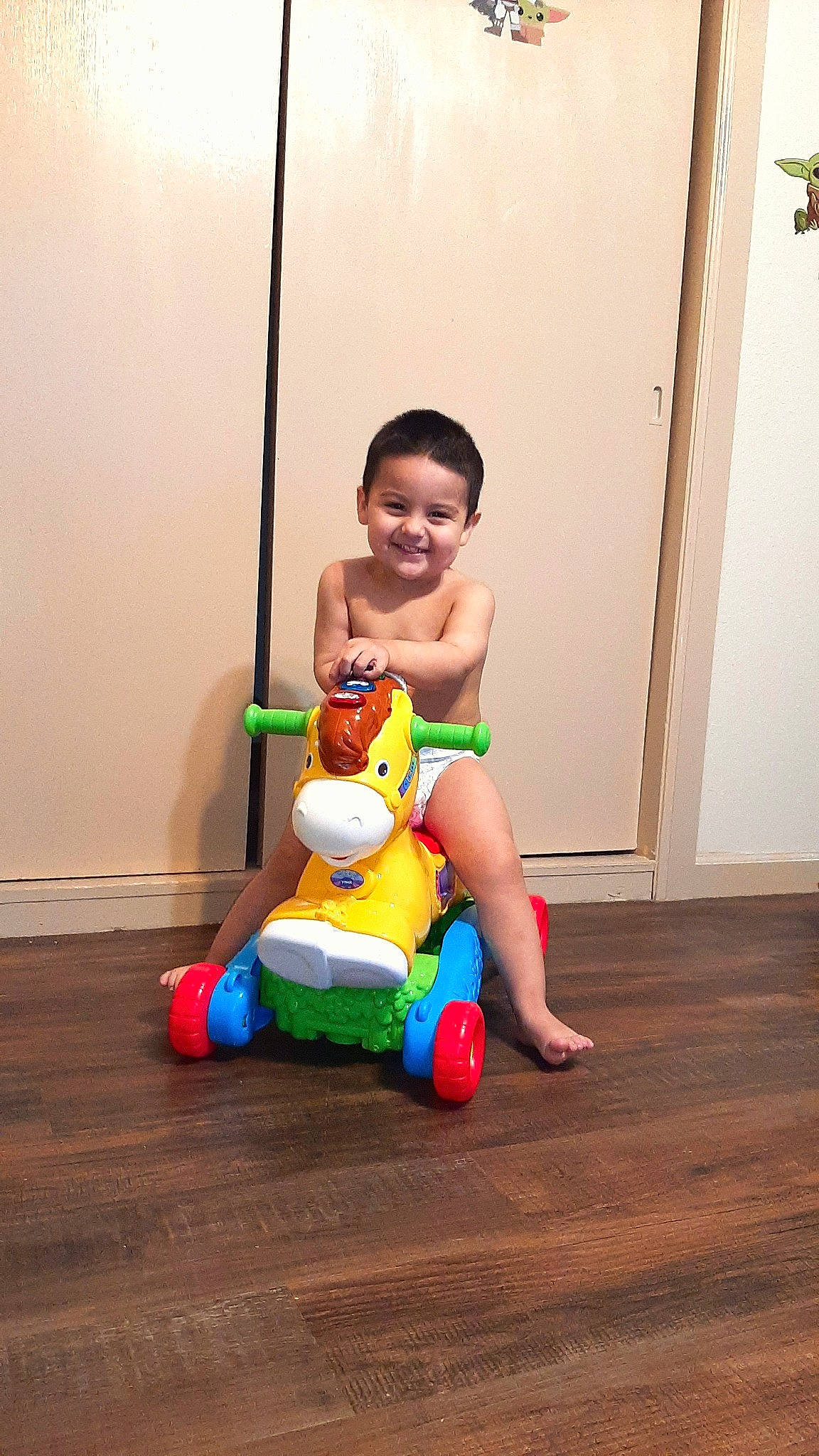 Slade joined the competition — help win amazing prizes! baby, baby_toddler_clothing, facial_expression, floor, flooring, hand, happy, human_body, human_leg, joy, knee, leg, leisure, musical_instrument, person, skin, smile, thigh, toddler, toy