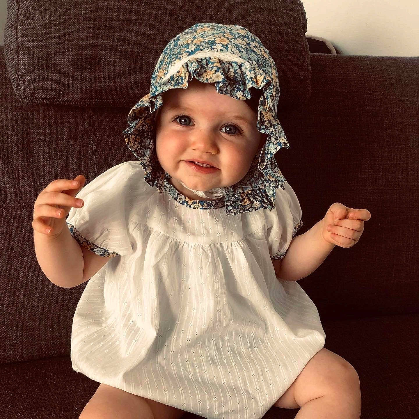 Rose participe au concours pour gagner de l'argent avec cette photo : baby, baby_toddler_clothing, cap, chest, costume_hat, dress, face, flash_photography, gesture, happy, headpiece, headwear, helmet, human_body, joy, pattern, person, selfie, sleeve, smile