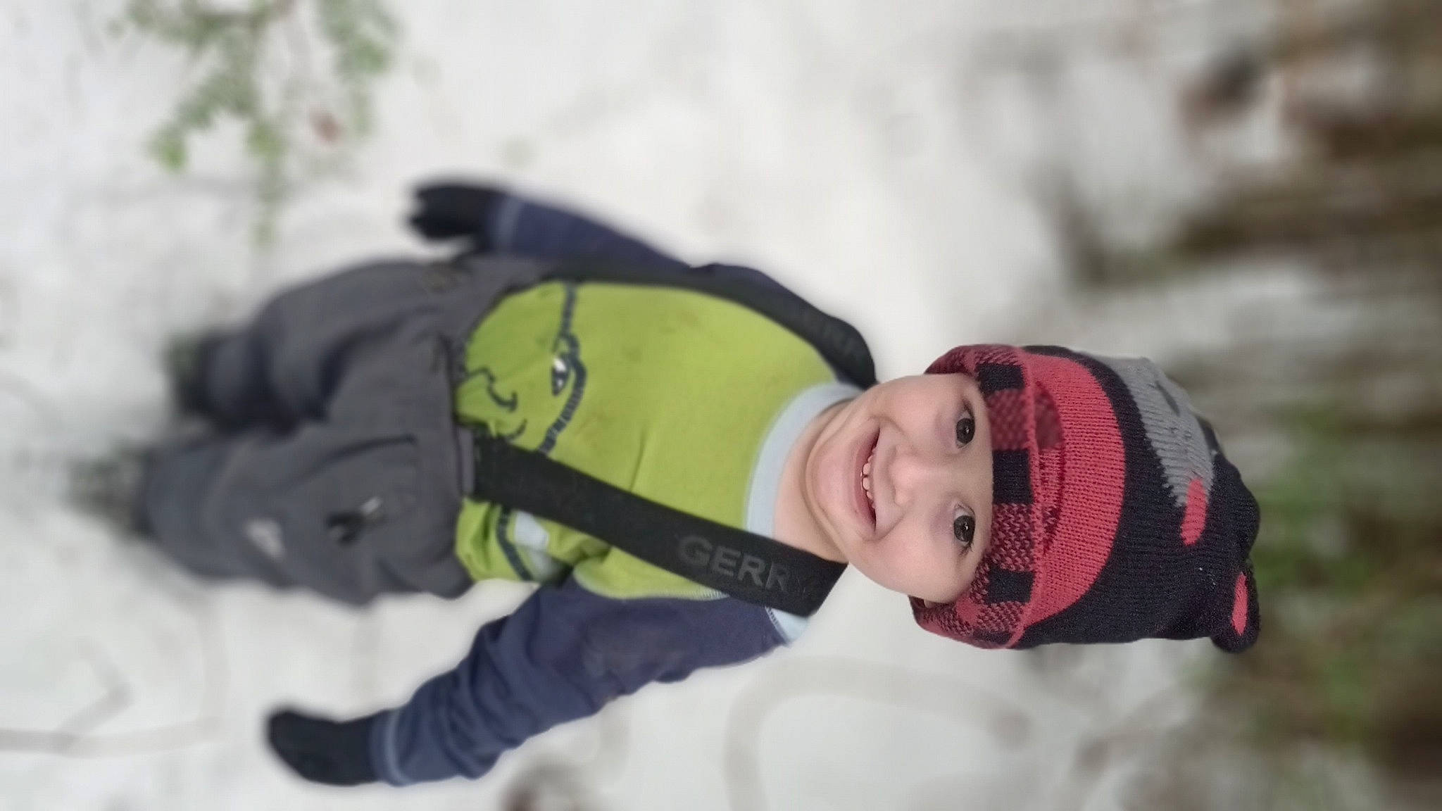 Reese is registered to the contest to win money with this photo: baby, baby_toddler_clothing, beanie, child, freezing, fun, happy, headwear, joy, knit_cap, leisure, person, plant, portrait_photography, recreation, smile, snow, toddler, tree, winter