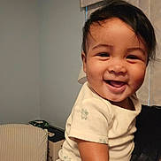 Adrian joined the competition — help win amazing prizes! baby, smiling, indoor, person, child, happy, face, skin, hand, clothing, short_sleeve, window, curtain, furniture, holding, cute, infant, portrait, light, warmth