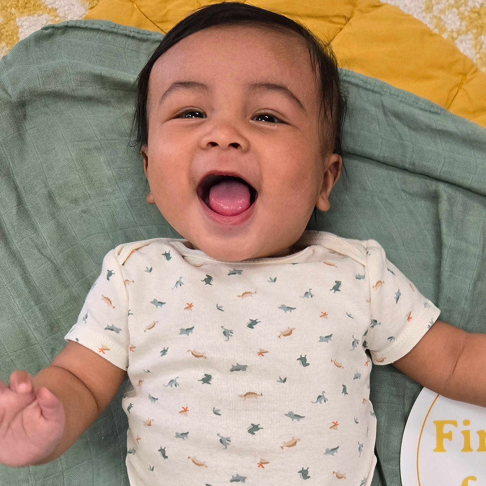 Adrian is registered to the contest to win money with this photo: baby, smiling, infant, onesie, blanket, happy, face, child, laying, cute, pattern, mouth_open, celebration, milestone, skin, arm, indoor, young_child, joy, expression
