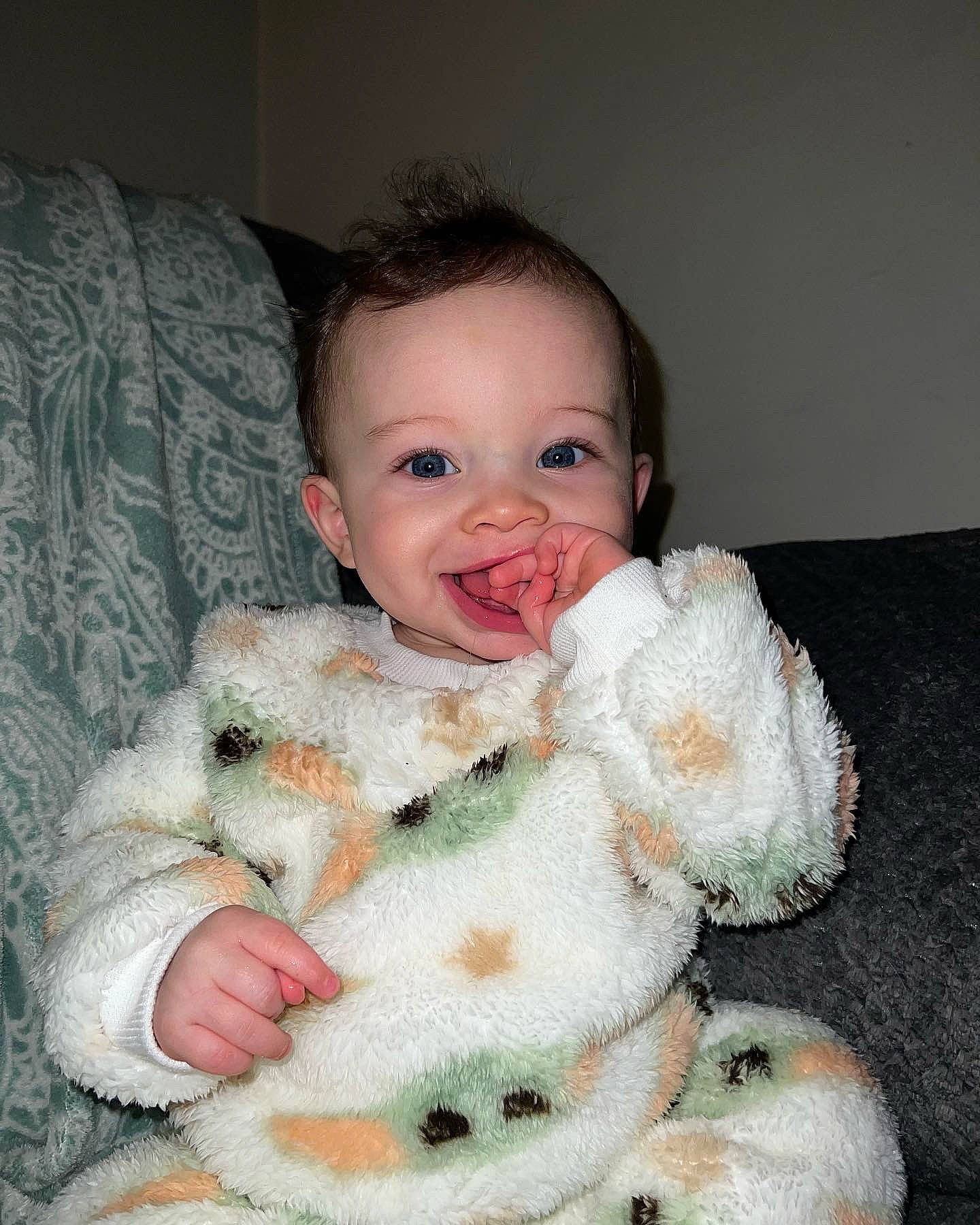 Marcel is registered to the contest to win money with this photo: arm, baby, baby_products, baby_toddler_clothing, cheek, child, comfort, eye, fur, happy, iris, joy, linens, pattern, person, room, sitting, skin, sleeve, smile