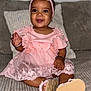 Keliyah a rejoint le concours — aidez-le/la à gagner de superbes lots ! baby, child, smiling, pink_dress, headband, sitting, indoors, couch, happy, cute, footwear, bracelet, lace, portrait, infant, young_child, female, apparel, person, cozy