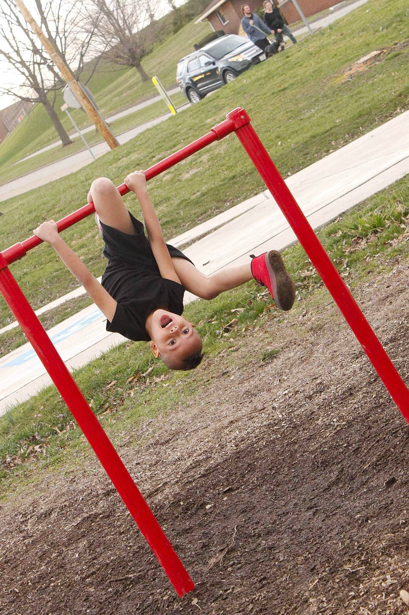 Zamari joined the competition — help win amazing prizes! balance, blurred, city, fun, grass, human_leg, knee, leisure, outdoor_play_equipment, people_in_nature, person, physical_fitness, plant, play, playground, recreation, shorts, soil, sports, swing