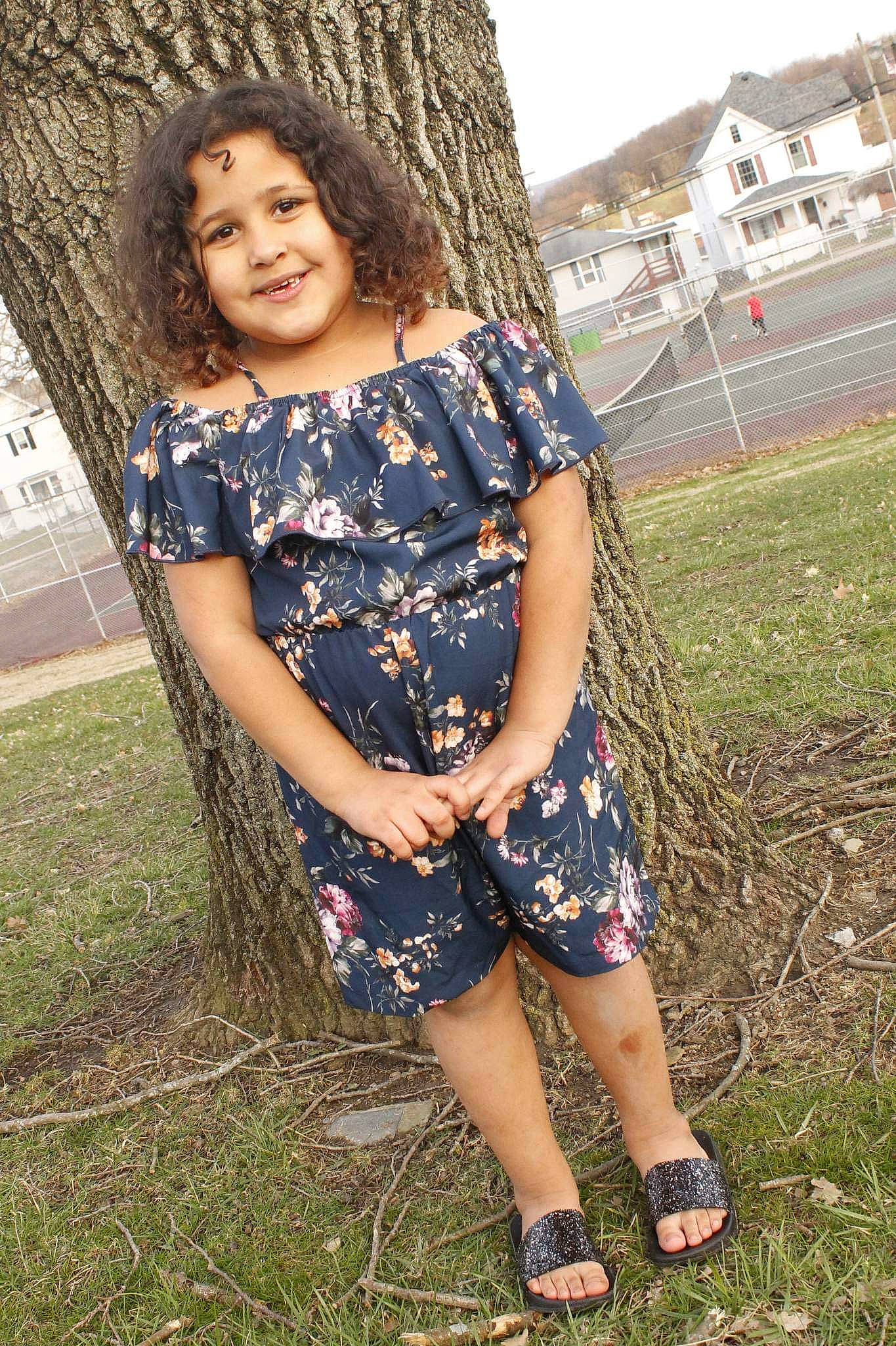 Zamyrah is registered to the contest to win money with this photo: child, eye, face, fashion_design, flash_photography, fun, grass, hair, happy, head, human_leg, joy, leg, long_hair, pattern, people_in_nature, person, plant, skin, thigh