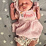 adorable, baby, blanket, child, closeup, cute, headband, indoor, infant, lying_down, newborn, patterned_clothing, peaceful, pink_clothing, portrait, sleeping, small_feet, small_hands, soft_texture, stars