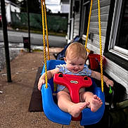 Mclane joined the competition — help win amazing prizes! baby, swing, outdoor, child, play, smile, happy, toys, feet, ropes, blue, red, yellow, porch, home, window, clothing, person, fun, daytime