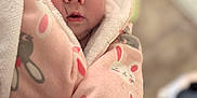 Mclane is registered to the contest to win money with this photo: baby, blanket, bunny_print, child, closeup, clothing, cozy, cute, expression, face, indoor, infant, love_text, newborn, person, pink, portrait, soft, warm, wrapped