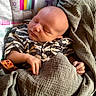 newborn, baby, sleeping, infant, portrait, face, blanket, swaddle, clothing, onesie, hand, arm, nursery, rainbow, cartoon, crib, cushion, indoors, peaceful, photography