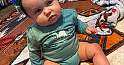 Freya joined the competition — help win amazing prizes! baby, blanket, carpet, child, christmas_tree_headband, curious, cute, decor, festive, floor, furniture, headwear, holiday, home, indoor, infant, long_sleeve, pattern, person, sitting