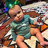 Freya joined the competition — help win amazing prizes! baby, child, christmas_tree_headband, holiday, indoor, carpet, blanket, furniture, pattern, curious, sitting, cute, festive, decor, person, home, floor, long_sleeve, infant, headwear