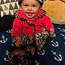 Freya joined the competition — help win amazing prizes! anchor_pattern, baby, beads, blanket, child, cozy, cute, happy, hat, indoor, person, pillow, plush, portrait, red_clothing, sitting, smiling, toy, warm, zebra_pattern