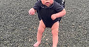 Rowen is registered to the contest to win money with this photo: toddler, child, swing, playground, outdoor, park, grass, trees, bench, equipment, person, seat, barefoot, casual_clothing, daytime, expression, curious, young_child, nature, recreation