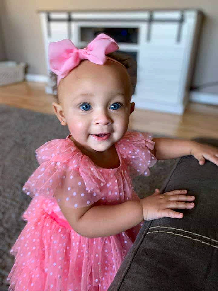 Rihanna is registered to the contest to win money with this photo: baby, baby_toddler_clothing, child, child_model, clothing, costume, dress, fashion_accessory, hair_accessory, headband, headgear, party, person, pink, skin, smile, toddler