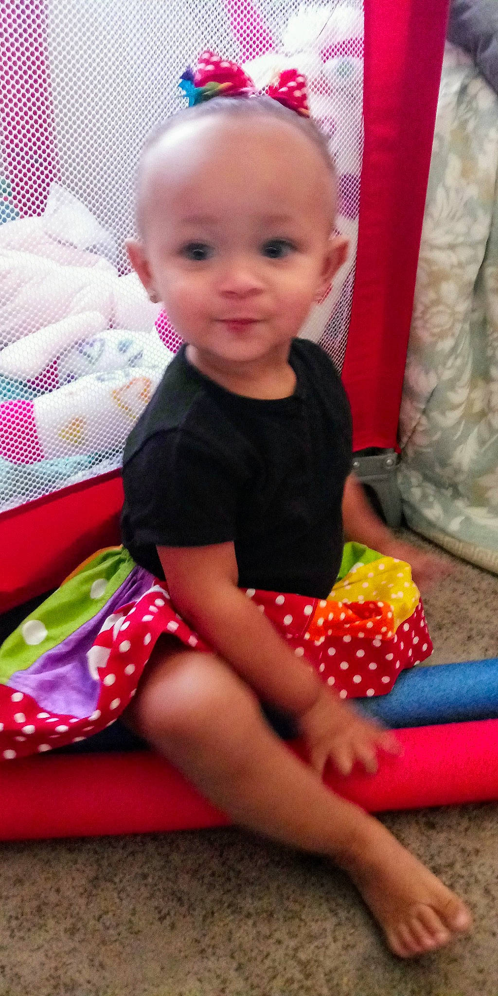 Rihanna is registered to the contest to win money with this photo: baby, baby_products, baby_toddler_clothing, cheek, child, design, dress, pattern, person, pink, play, polka_dot, product, sitting, skin, smile, textile, toddler