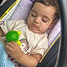 baby, sleeping, car_seat, infant, toy, turtle_toy, blanket, blue_blanket, vehicle, portrait, child, peaceful, cozy, seated, curly_hair, closed_eyes, casual_clothing, indoors,  안전, photograph