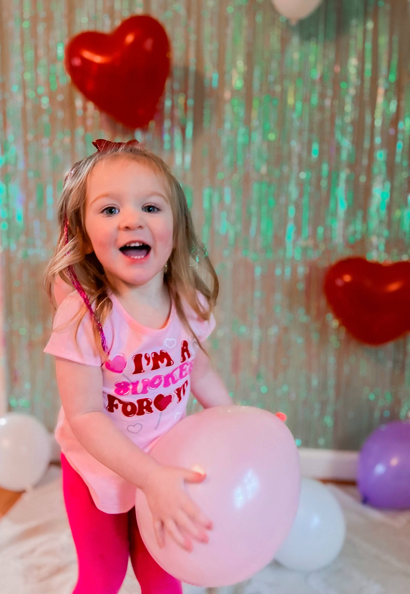 Kyleigh is registered to the contest to win money with this photo: baby, baby_toddler_clothing, balloon, child, clothing, event, fun, happy, leisure, magenta, party, party_supply, person, pink, play, portrait_photography, recreation, sitting, smile, thigh