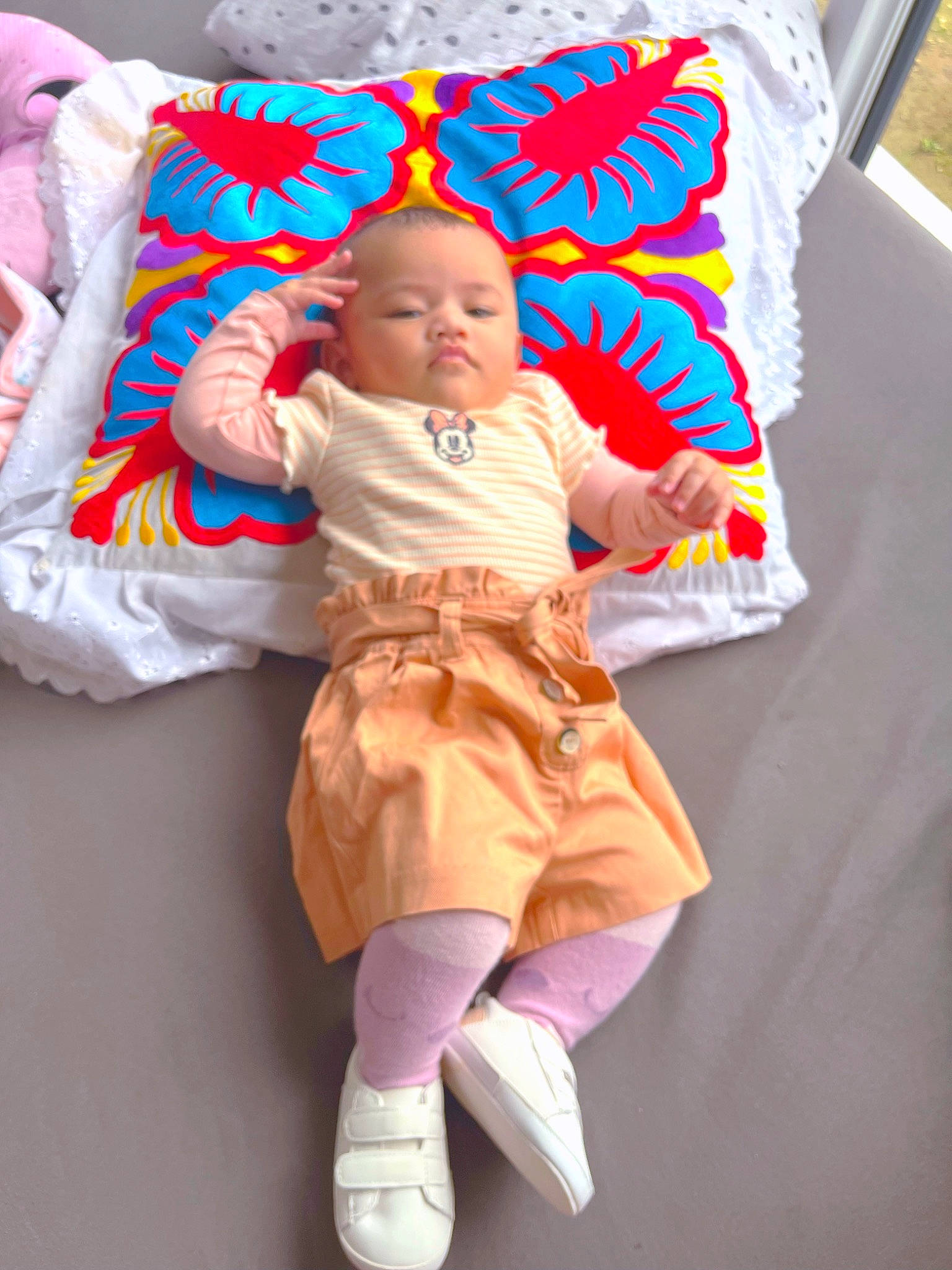 Mani Graëce Manogitau a rejoint le concours — aidez-le/la à gagner de superbes lots ! baby, baby_products, baby_toddler_clothing, child, comfort, couch, fashion_accessory, human_leg, knee, linens, magenta, person, pillow, pink, room, sitting, sleeve, sock, textile, throw_pillow