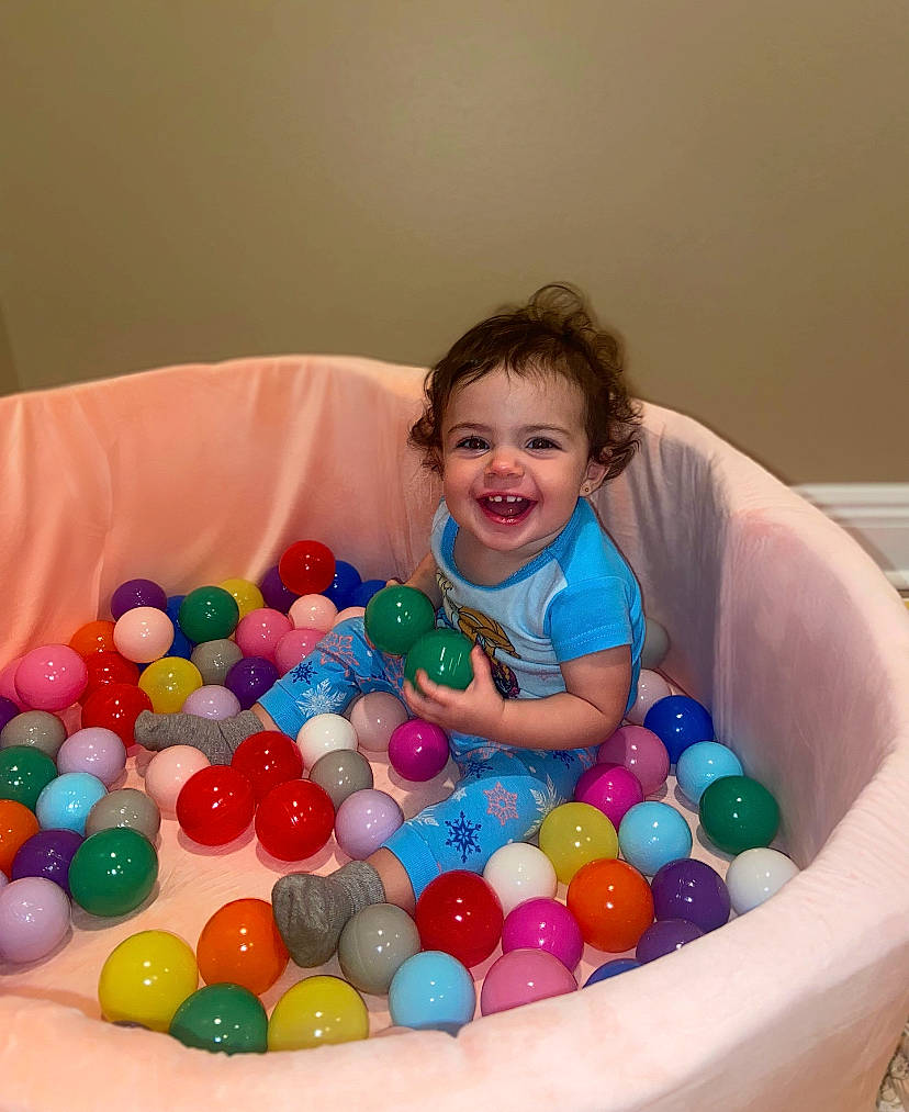 Presley is registered to the contest to win money with this photo: baby, baby_playing_with_toys, ball, ball_pit, child, event, eye, face, fun, happy, head, joy, leisure, party_supply, person, play, product, recreation, smile, sweetness
