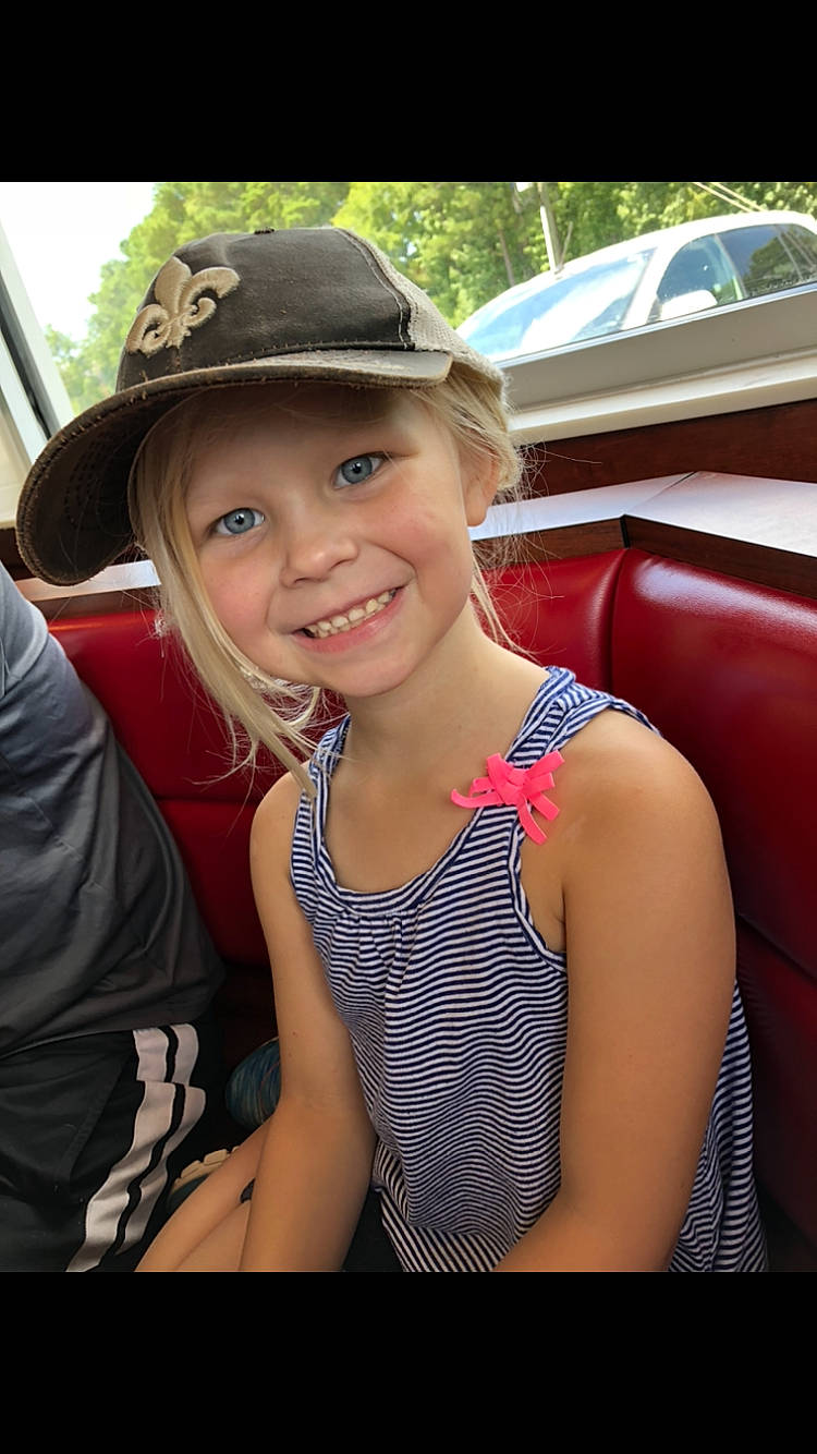 Savannah is registered to the contest to win money with this photo: blond, fashion_accessory, fawn, hat, headgear, headwear, joy, lady, person, sitting, smile, summer, sun_hat, vacation