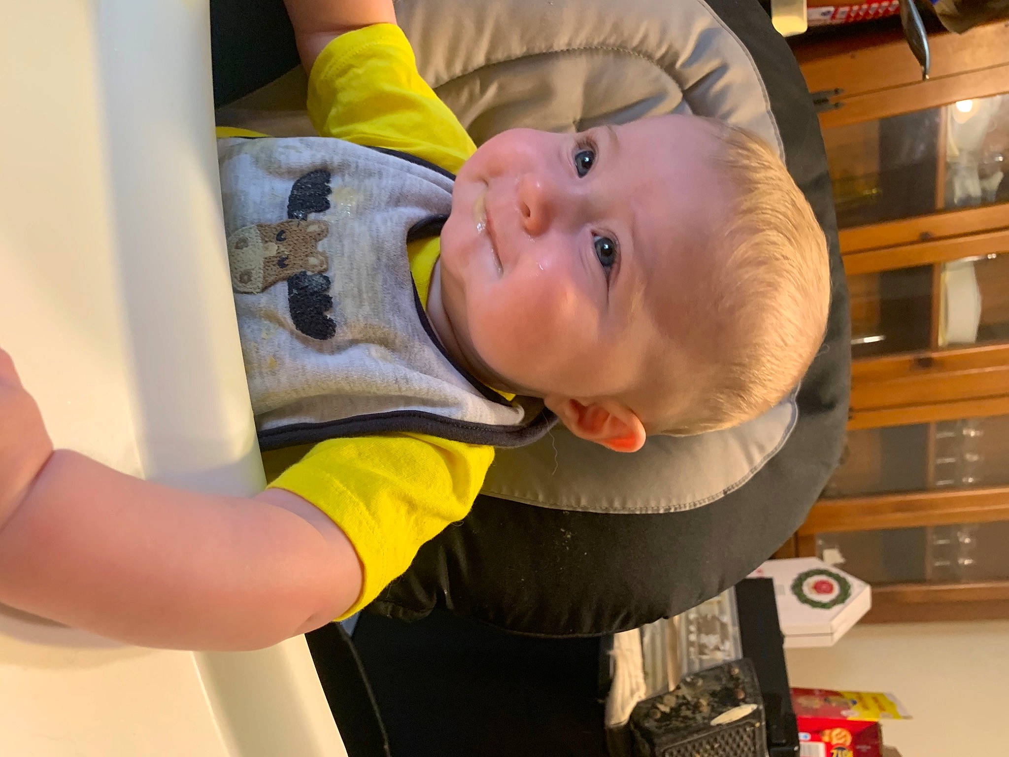 Cullen is registered to the contest to win money with this photo: baby, baby_products, baby_safety, baby_toddler_clothing, cheek, child, elbow, fun, happy, person, room, shelf, t_shirt, toddler, wood