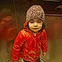 Gioia Maria a rejoint le concours — aidez-le/la à gagner de superbes lots ! child, toddler, red_jacket, knitted_hat, elevator, reflection, winter_clothing, standing, indoor, metal_wall, curly_hair, footwear, pants, casual, portrait, young_child, cold_weather, cute, expression, cozy