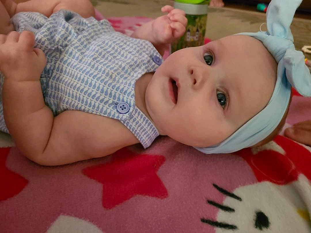 Rowan joined the competition — help win amazing prizes! baby, baby_products, baby_toddler_clothing, cheek, child, comfort, eyelash, finger, fun, grass, happy, hat, headwear, nail, pattern, person, sitting, skin, thigh, toddler