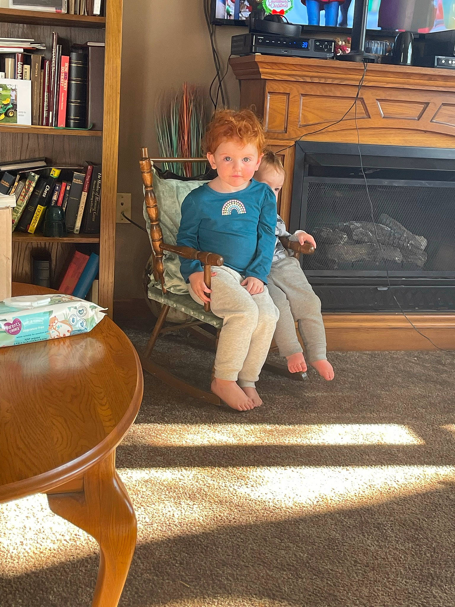 Addisynn joined the competition — help win amazing prizes! bookcase, child, comfort, couch, floor, flooring, furniture, hardwood, home_appliance, leg, leisure, living_room, person, shelf, standing, table, television, television_set, thigh, toddler