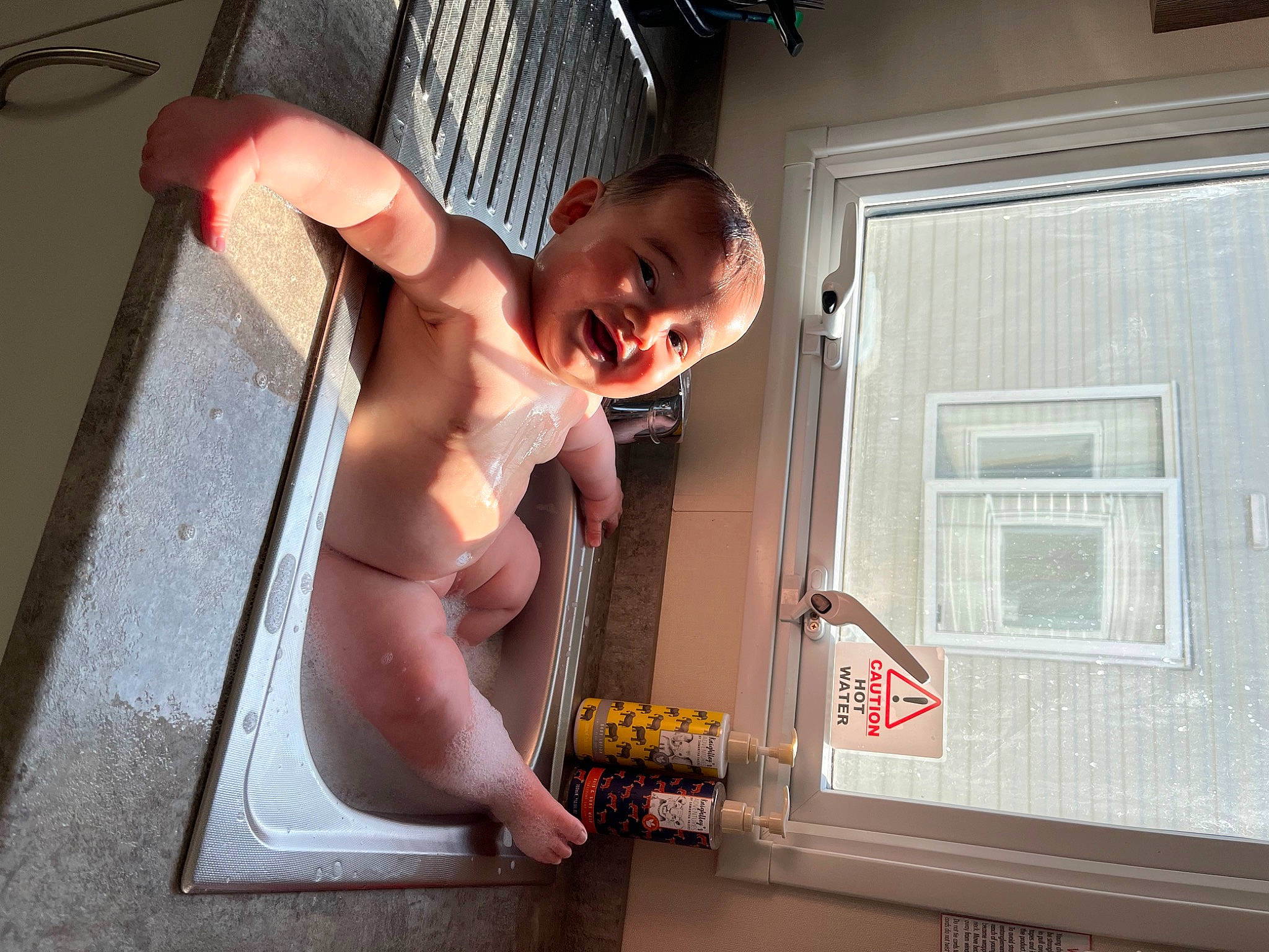 Franky is registered to the contest to win money with this photo: abdomen, barechested, bathing, chest, child, elbow, eyewear, flash_photography, flesh, flooring, fun, glasses, human_leg, person, room, stomach, sunglasses, thigh, toddler, trunk