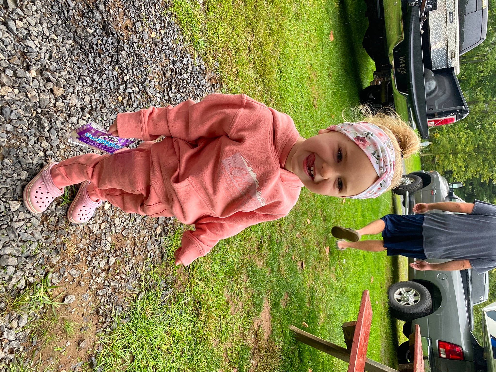 Chandler is registered to the contest to win money with this photo: automotive_exterior, baby, car, child, family_car, fun, grass, headwear, joy, lawn, leisure, motor_vehicle, people_in_nature, person, plant, recreation, soil, tire, toddler, tree