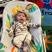 Oakley joined the competition — help win amazing prizes! baby, infant, headband, monkey_pattern, baby_rocker, colorful, playmat, animal_prints, smiling, child, indoors, clothing, cute, happy, seat, toy, floor, comfort, expression, young