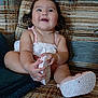 Penelope joined the competition — help win amazing prizes! baby, child, smiling, happy, sitting, shoe, footwear, couch, furniture, indoors, pattern, clothing, cute, portrait, skin, person, hair, face, toddler, playful