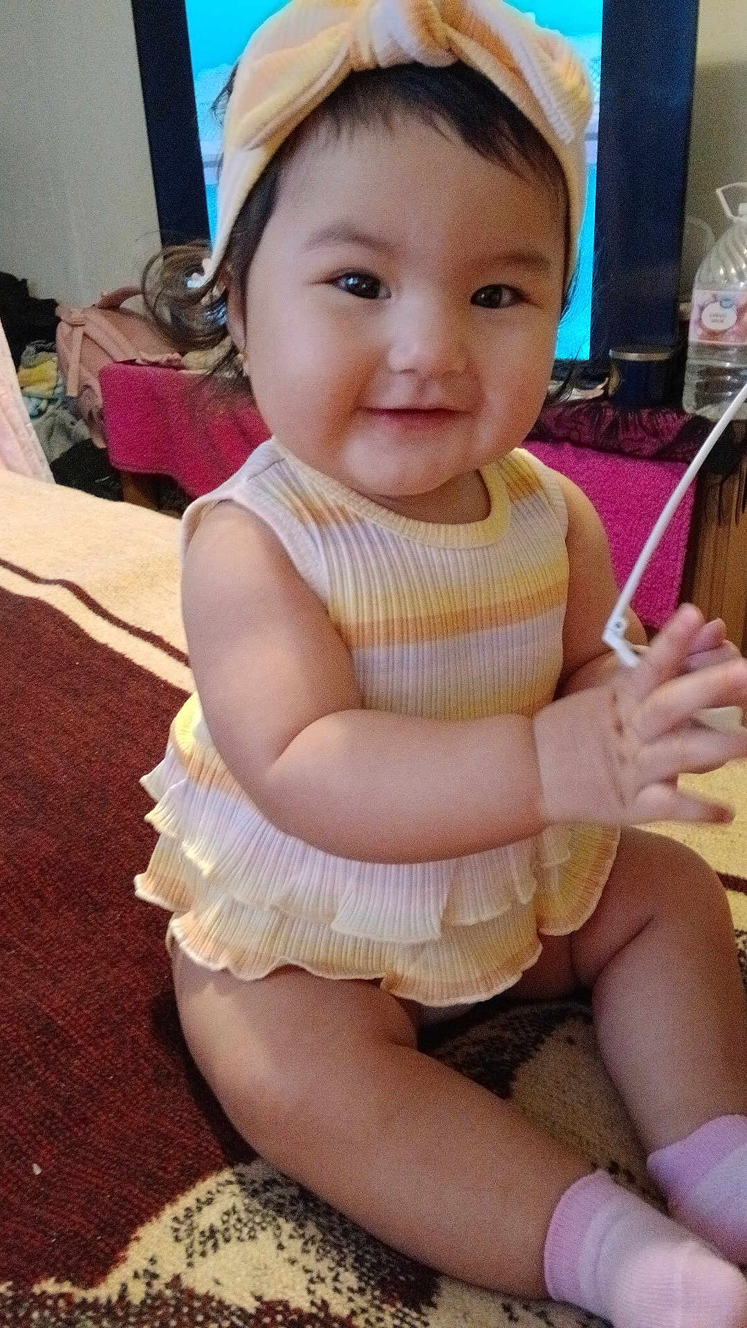 Penelope joined the competition — help win amazing prizes! baby, child, smiling, headband, dress, sitting, clapping, carpet, indoors, cute, joyful, pastel_colors, furniture, television, sock, chubby_cheeks, portrait, young_child, happy, person
