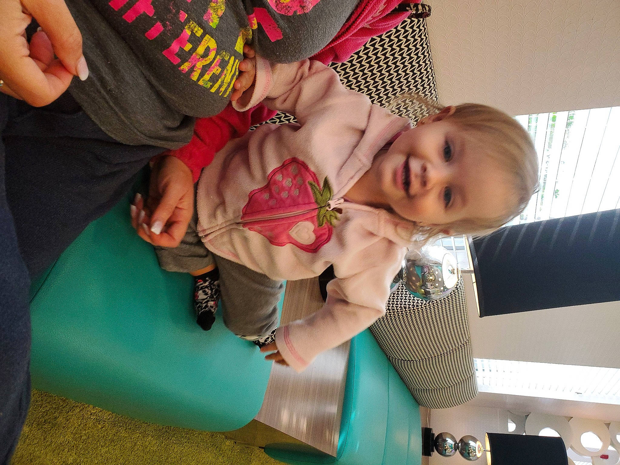 Greylynn joined the competition — help win amazing prizes! baby, baby_toddler_clothing, child, comfort, dress, event, finger, fun, happy, human_body, joy, lap, leg, person, sitting, skin, smile, sock, thigh, toddler