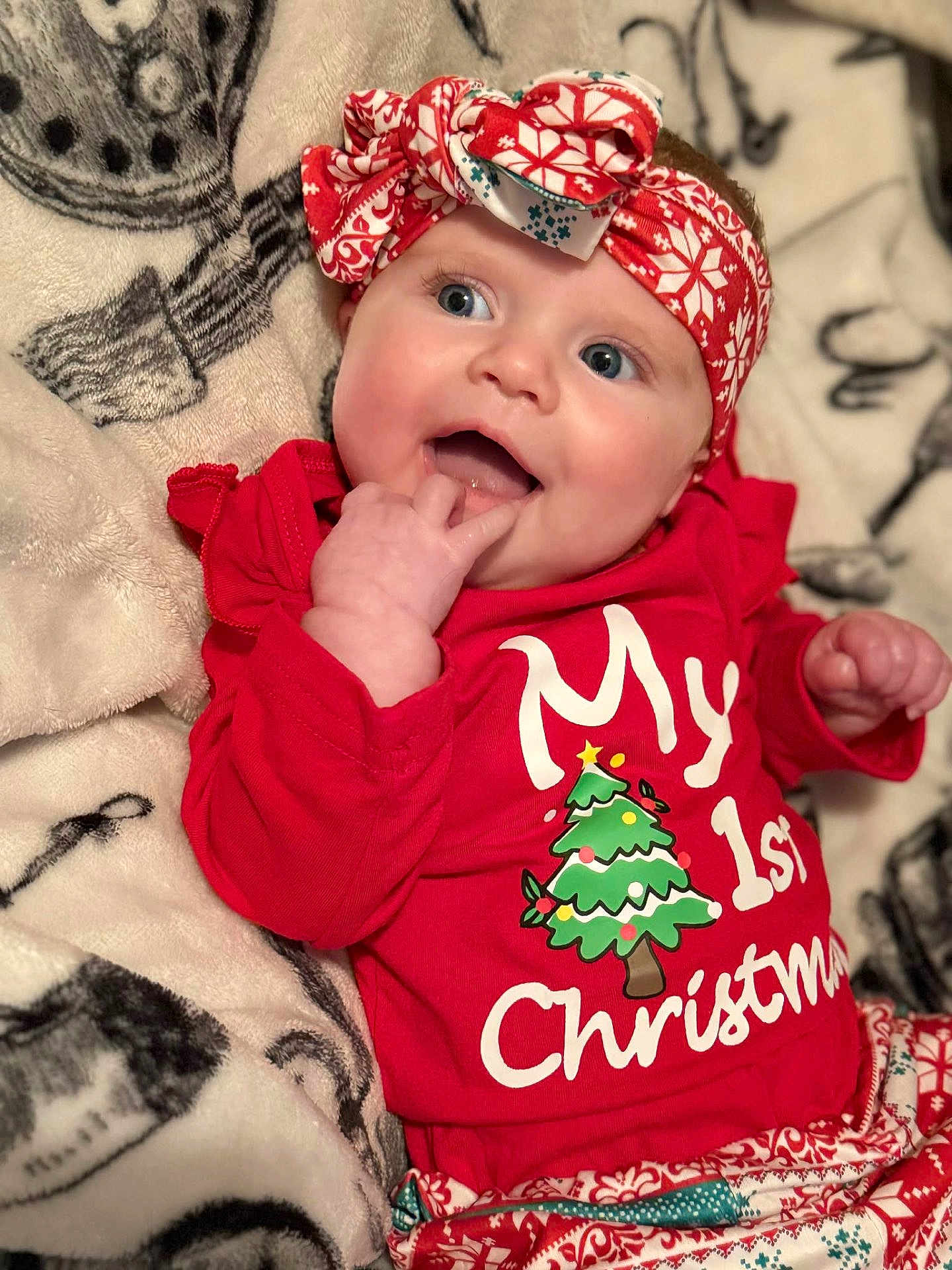 Maria joined the competition — help win amazing prizes! baby, infant, child, red_clothing, headband, christmas, holiday, smiling, happy, blanket, pattern, cute, festive, indoors, portrait, face, hand, blue_eyes, soft_texture, cozy