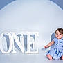 baby, child, girl, dress, barefoot, smile, blue_dress, first_birthday, letters, one, studio, spotlight, portrait, sitting, cute, young_child, celebration, happy, indoor, person