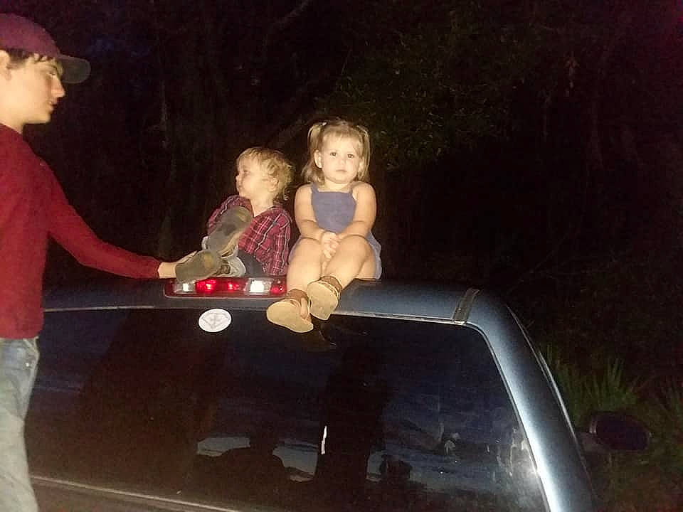 Destiny is registered to the contest to win money with this photo: automotive_exterior, automotive_lighting, baby, bumper, child, flash_photography, fun, happy, hood, lap, leisure, motor_vehicle, person, recreation, sitting, t_shirt, toddler, toy, trunk, vehicle_door