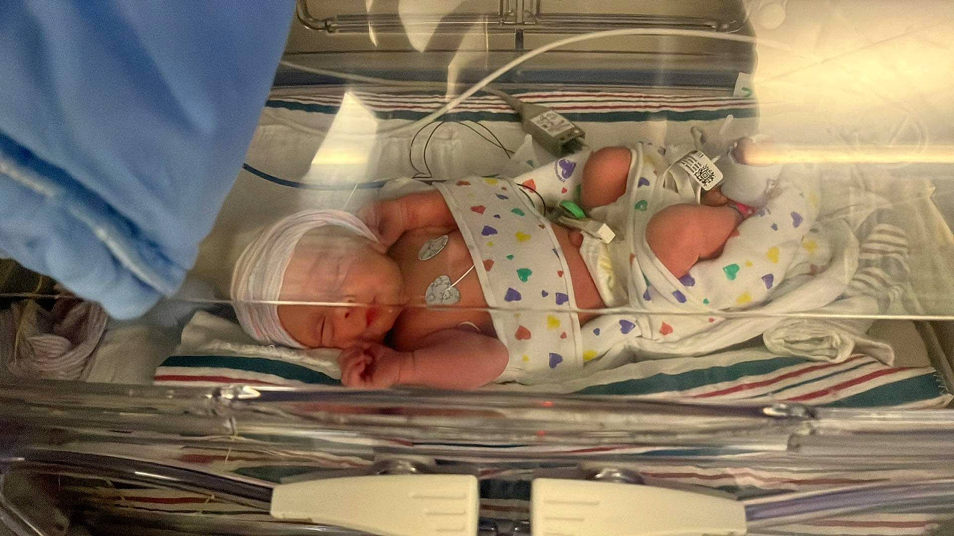 River Lee is registered to the contest to win money with this photo: art, baby, baby_products, bedding, child, childbirth, comfort, health_care, hospital, hospital_bed, linens, medical, medical_equipment, medical_procedure, patient, pattern, person, room, service, textile