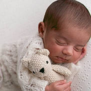 Naksh is registered to the contest to win money with this photo: newborn, baby, sleeping, knit_blanket, crocheted_toy, teddy_bear, soft_texture, white_background, peaceful, infant, closeup, portrait, cute, cozy, hand, face, child, resting, warm, adorable
