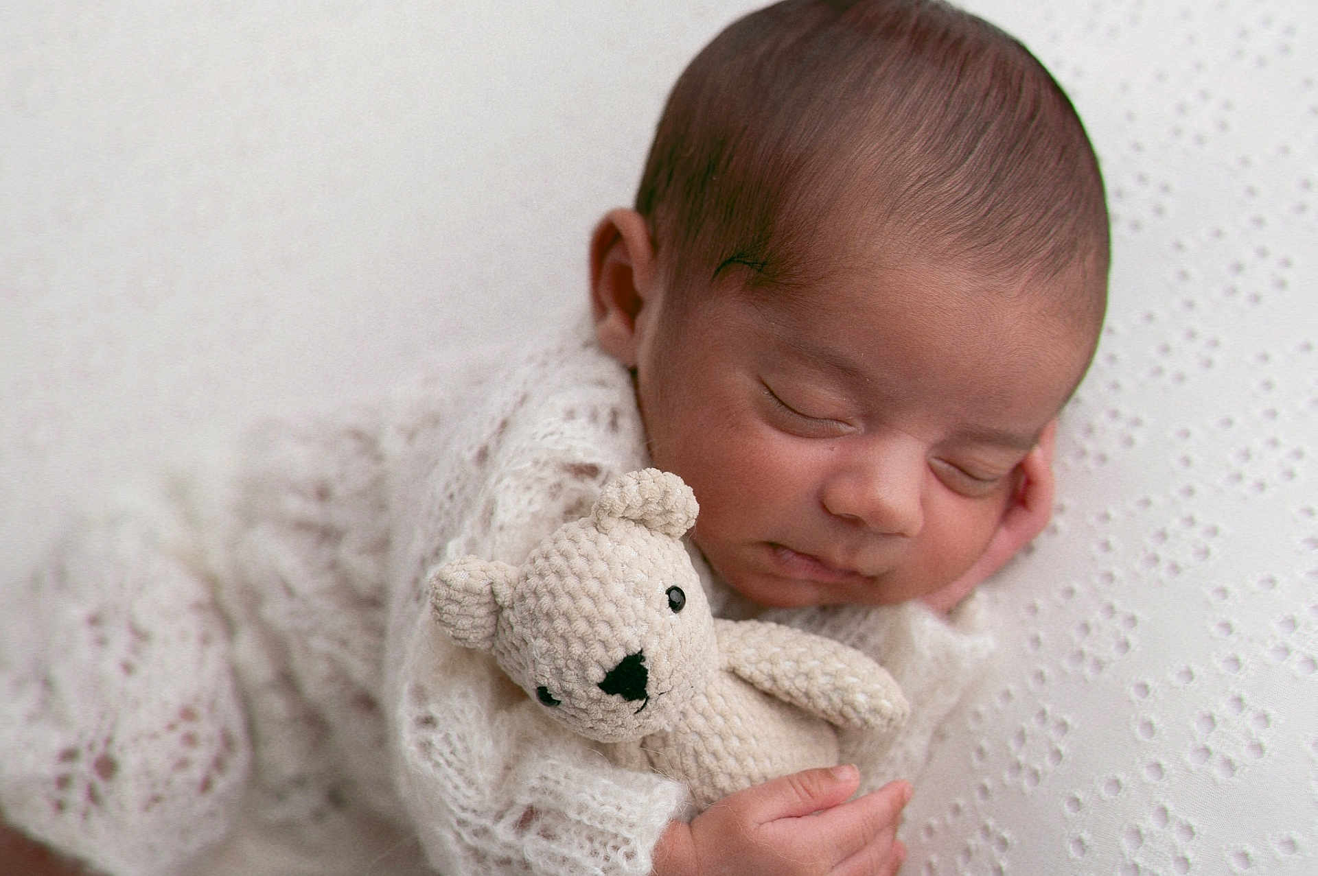 Naksh is registered to the contest to win money with this photo: newborn, baby, sleeping, knit_blanket, crocheted_toy, teddy_bear, soft_texture, white_background, peaceful, infant, closeup, portrait, cute, cozy, hand, face, child, resting, warm, adorable