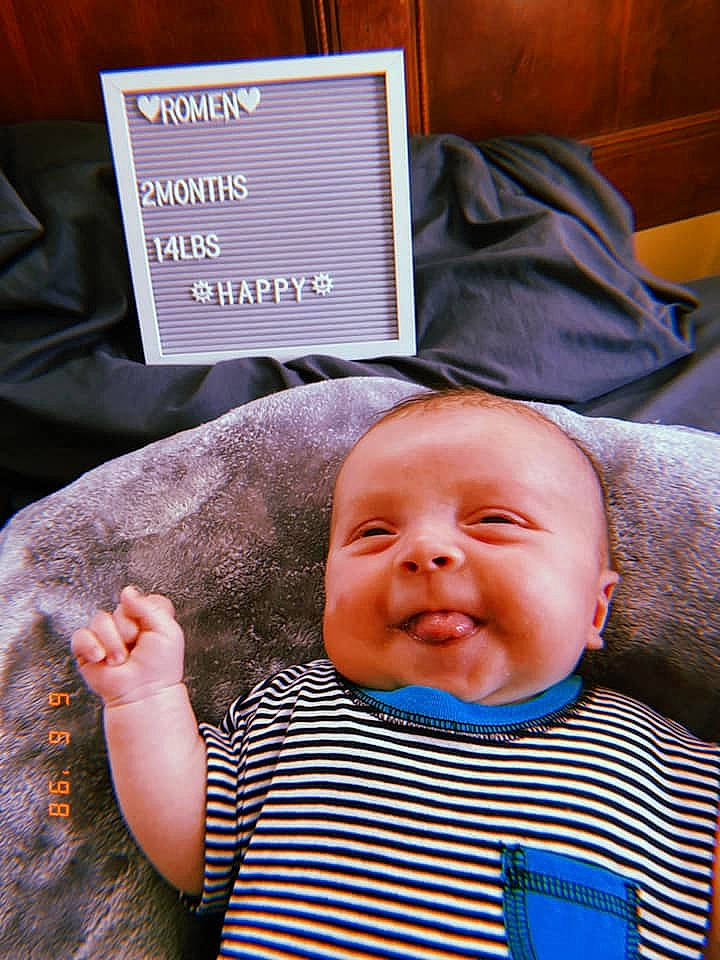 Romen is registered to the contest to win money with this photo: baby, baby_products, baby_toddler_clothing, cheek, child, chin, comfort, gesture, happy, human, laugh, linens, pattern, person, sitting, skin, sleeve, smile, toddler