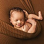 newborn, baby, sleeping, blanket, brown, knitted, cozy, infant, cute, smile, curled_up, peaceful, skin, hand, foot, portrait, closeup, resting, wrapped, soft