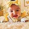 baby, child, closeup, clothing, cozy, cute, cute_outfit, decor, fluffy_rug, happy, headband, indoor, infant, plant, portrait, smiling, soft_toys, teddy_bear, warm_lighting, yellow_bow