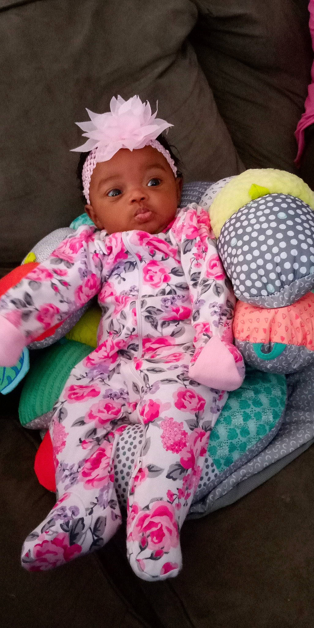 Savanna is registered to the contest to win money with this photo: arm, baby, baby_toddler_clothing, cap, cheek, comfort, finger, head, headgear, headwear, magenta, mammal, person, pink, product, skin, sleeve, sock, textile, thigh