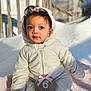 6_months, baby, blanket, child, cozy, cute, expression, face, headwear, infant, onesie, outdoor, pink_bow, portrait, sitting, snow, soft_light, winter_clothing, wooden_sign, young_child