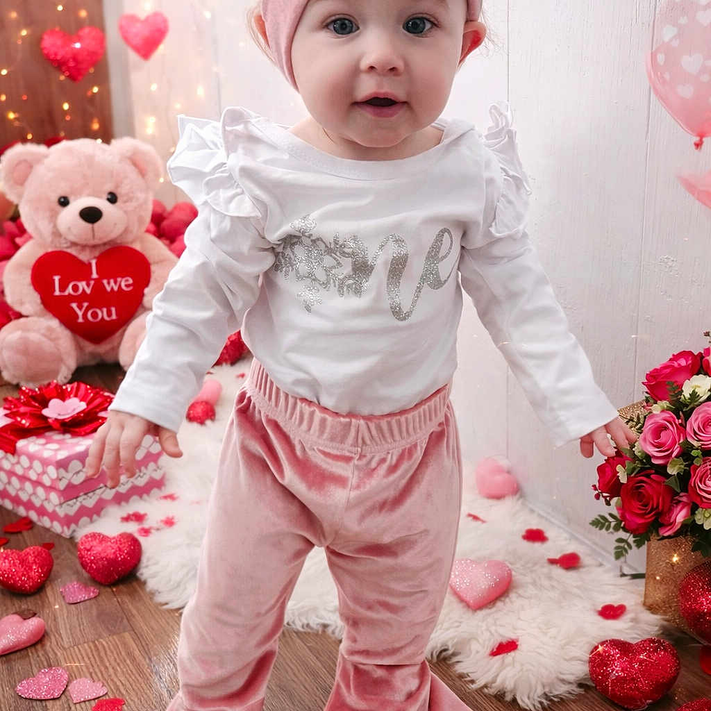 Kinnison is registered to the contest to win money with this photo: baby, bouquet, child, confetti, curious_expression, cute, floor_rug, gift_box, heart_decorations, holiday_theme, indoor, pink_headband, portrait, roses, teddy_bear, toddler, valentines_day, velvet_pants, white_shirt, wooden_floor