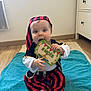 Paul a rejoint le concours — aidez-le/la à gagner de superbes lots ! baby, infant, milestone_card, 8_mois, pirate_costume, striped_pants, striped_headscarf, sitting, chews_card, barefoot, blue_towel, wooden_floor, dresser, indoor, big_eyes, fair_skin, portrait, cute, baby_smile, playtime