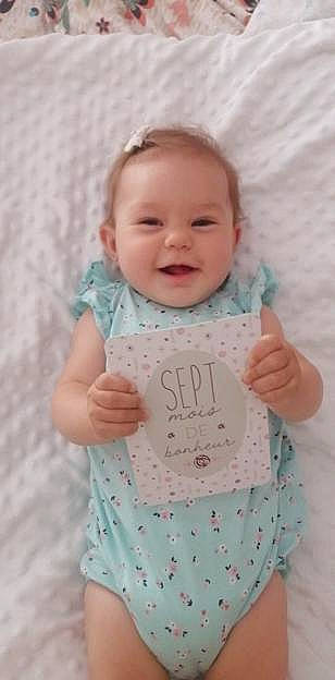 élia participe au concours pour gagner de l'argent avec cette photo : arm, azure, baby_toddler_clothing, cheek, dress, face, finger, gesture, hand, happy, head, joy, neck, nose, outerwear, person, pink, product, skin, sleeve