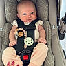 baby, car_seat, infant, child, seatbelt, polka_dot, hand, nails, red_nails, pink_clothing, foot, sitting, cute, smile, indoor, safety, parent, newborn, toddler, comfort
